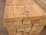 several stacks of lumber stacked on top of each other in a warehouse