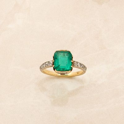 an image of a ring with a green stone