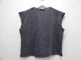 a black top with studded shoulders hanging on a hanger