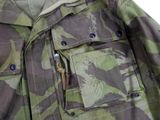 a close up of a camouflage jacket with buttons on it