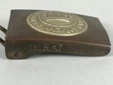 a metal belt buckle with a brass emblem on it