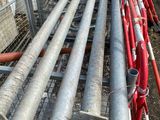 a bunch of pipes that are next to a fence