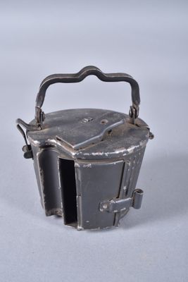 a small metal container with a handle on it