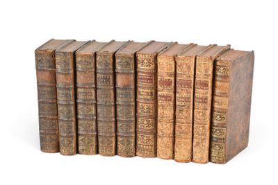 six vieux livres empilés sur une surface blanche