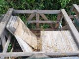 a pile of wood sitting on top of a pile of hay