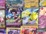 a lot of different pokemon cards on the table