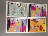 four children ' s books are lined up in a row on a table