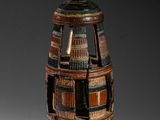 a vase that is made out of many different pieces of wood
