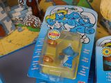 a blue and yellow smurch figure in a blue package