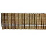a lot of books that are lined up on a shelf