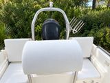 a white boat with a white seat and a black and white engine