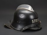an old black helmet with the word strike written on it