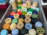 many different colors of paint in a container on the table