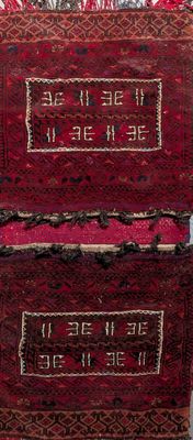 an image of a red and black rug sitting on top of a wooden table