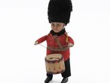 toy soldier holding a drum and wearing a red uniform