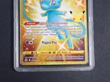 a pokemon card in a plastic case on a table