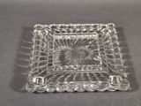 rectangular clear glass dish with a decorative design on the rim