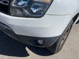 the front end of a white truck parked in a parking lot
