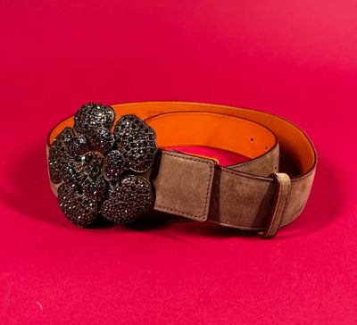 a close up of a belt with a flower on it
