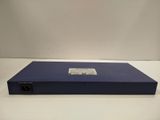 a close up of a blue box on a white surface