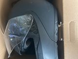 a cardboard box with a helmet inside of it