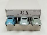 three toy cars sitting in a box on a table