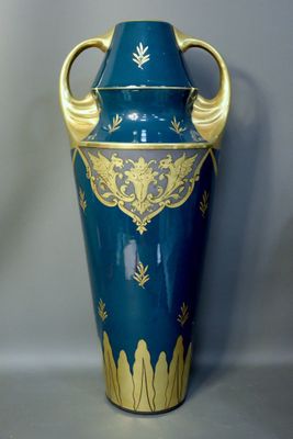 a large blue vase with gold decoration on it