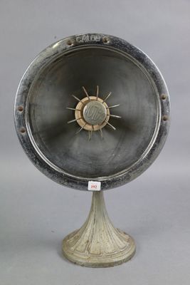 a large metal object on a stand with a clock on it