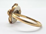 a close up of a ring on a white surface