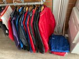 a lot of clothes hanging on a rack in a room