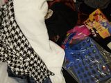 a pile of clothes on a bed in a room