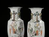 two vases that are sitting on a black surface