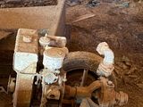 an old machine that is sitting in the dirt