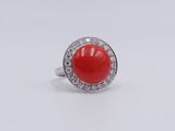 an image of a red coral and diamond ring on a white background