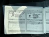 a passport sitting in the passenger seat of a car