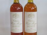 two bottles of wine sitting next to each other on a table