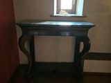 a small table in the corner of a room with a window