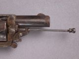 a small gun that is on a white surface