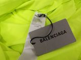 a close up of a yellow jacket with a tag on it