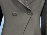 a close up of a suit with a yellow tie on a mannequin mannequin mannequin mannequin mannequin mannequin manne