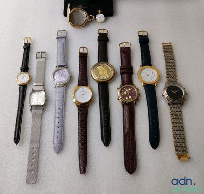 a lot of watches that are laying out on the table