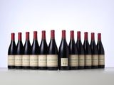 six bottles of wine lined up in a row on a table
