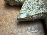 two rocks on a table with a knife on it