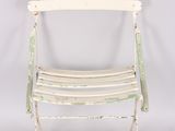 an old white metal folding chair against a white background