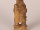 statue of a woman with a basket on her back