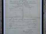 an old document with a red stamp on it is hanging on a wall