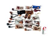 many different types of smoking pipes on a white surface