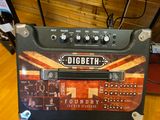 a guitar amp sitting on top of a wooden table
