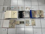 a lot of books on the floor with stamps on them