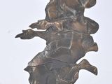 statue of a woman riding a horse on a black base